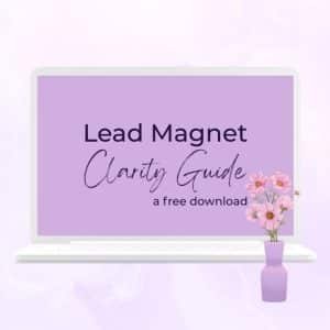 A soft lavender graphic of a laptop screen displaying the words “Lead Magnet Clarity Guide” with smaller text underneath reading “a free download.” Pink flowers decorate the bottom right corner of the image.